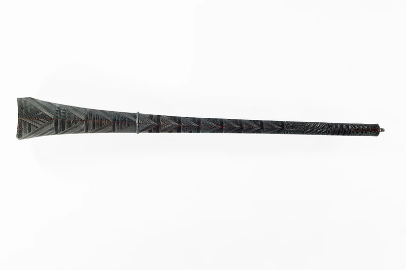 A long carved wooden club