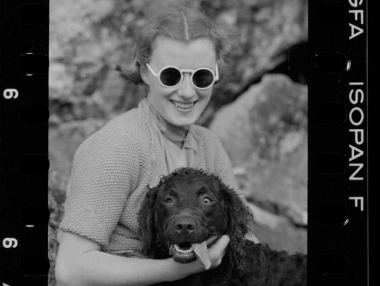 A woman with a dog. The dog's eyes are crossed and his tongue is out