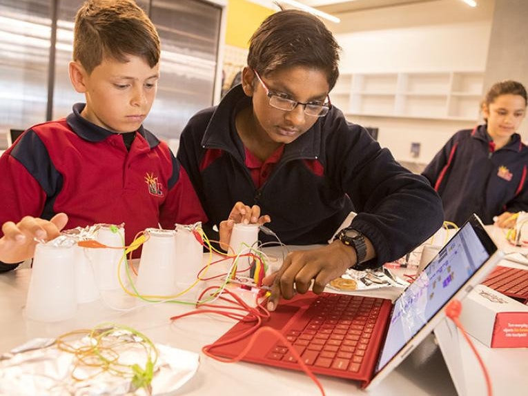 Hīnātore students working with Makey Makey technology. Photograph by Mike O'Neill Students play with a computer