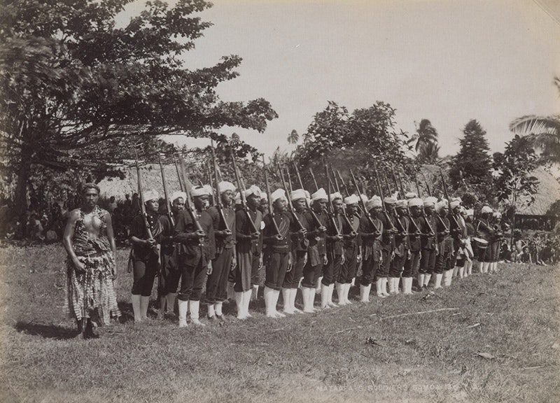 A black and white photo of a line up of people dressed in uniform