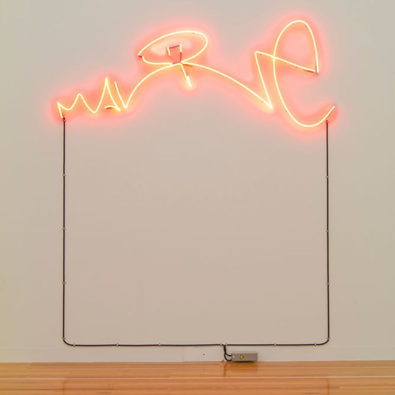 Neon lighting on a wall in the shape of the word Malone, scripted like a signature