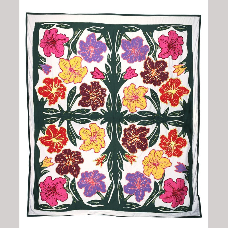 Brightly coloured pacific flowers arranged in a symmetrical pattern on a white background