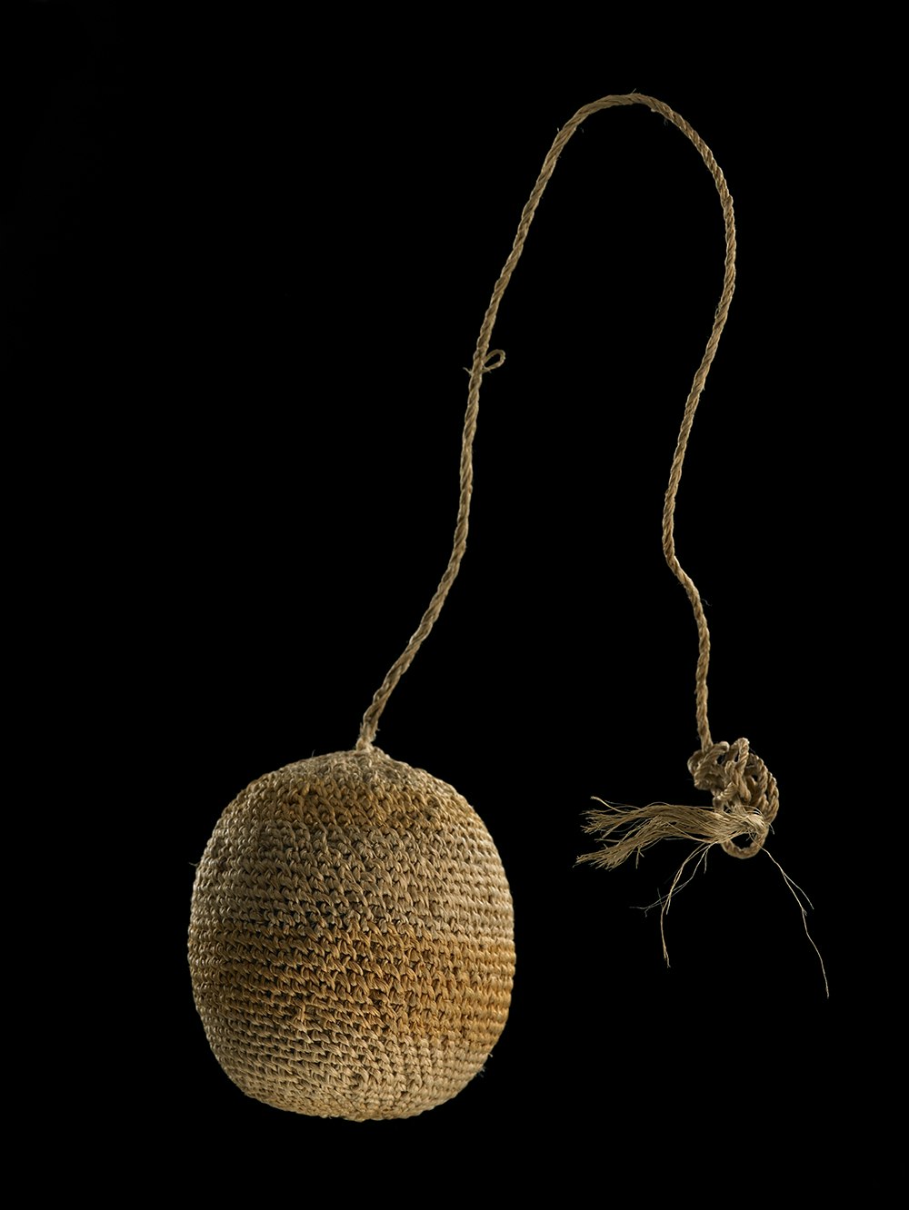 A woven ball with a cord connected to it