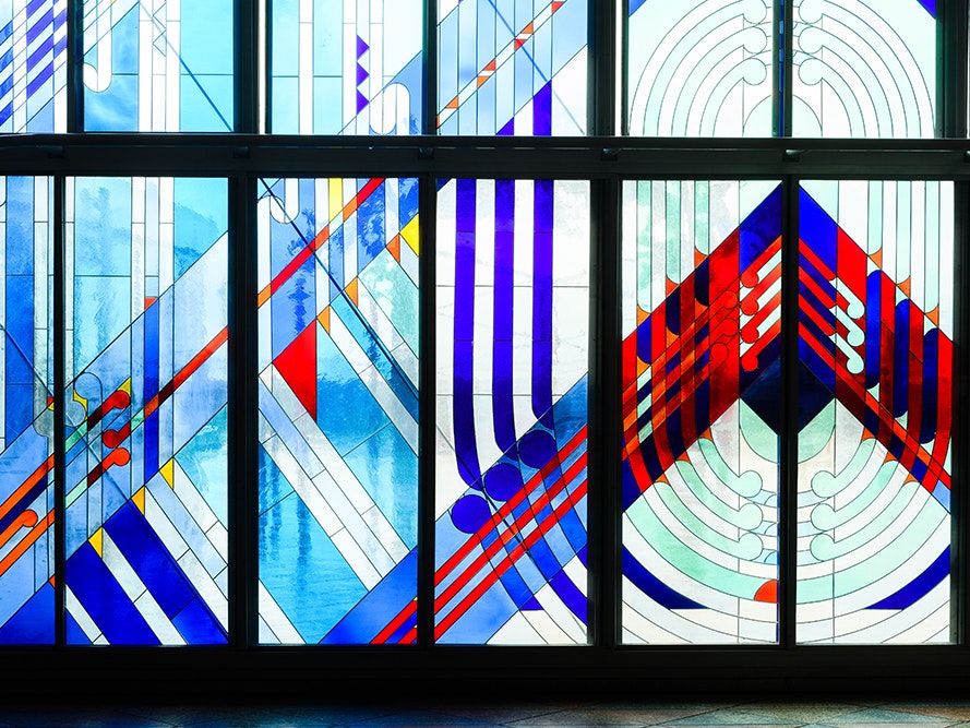 Robert Jahnke (designer), Ranginui (stained glass window), 1997, 2017. Photo by Mark Coote. Te Papa (107223) Stained glass window with red and blue lines, symbols and shapes.