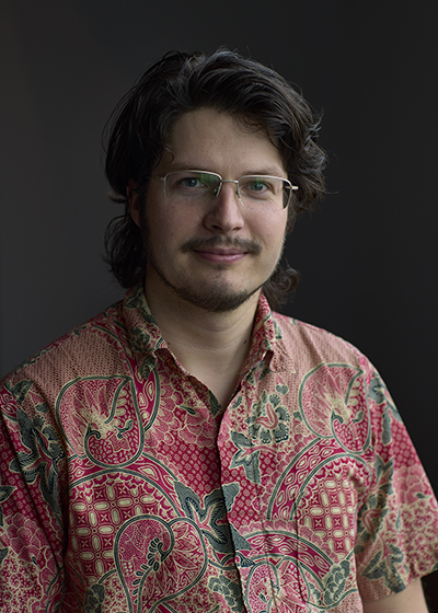 Head and shoulders photo of a man smiling at the camera