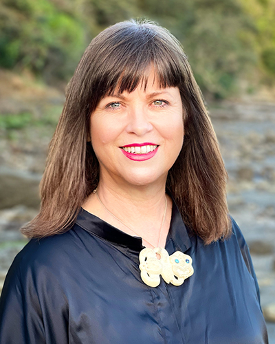 Head and shoulders photo of a woman with long brown hair.