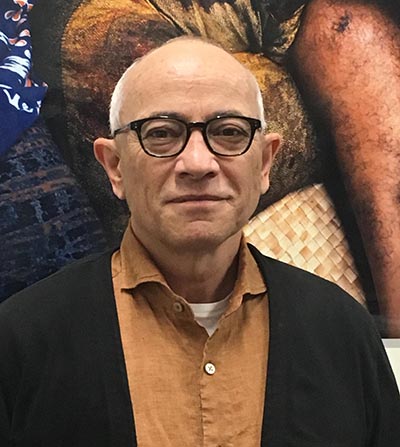 Head and shoulders of a man in glasses looking at the camera.