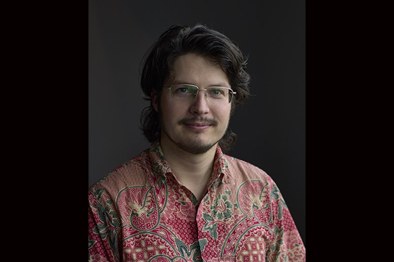 Head and shoulders photo of a man smiling at the camera
