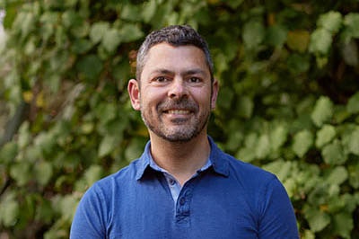 Head and shoulders of a man smiling at the camera.
