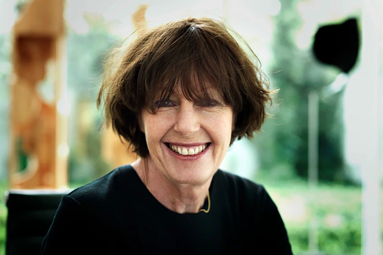 Head and shoulders photo of a woman with short dark hair. She is smiling at the camera.