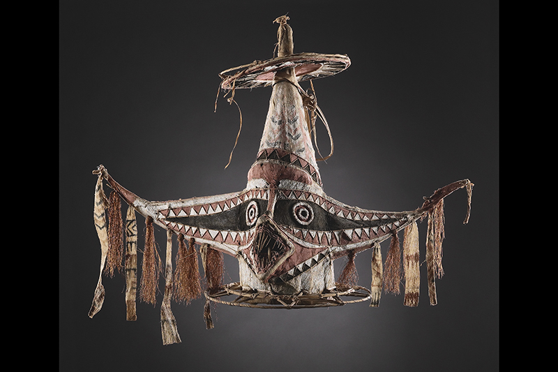 A large mask made of tapa and cane.