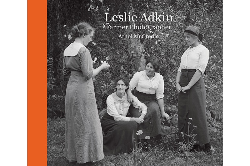 A book cover with a black and white photo of four women by a tree and the words Leslie Adkin Farmer Photographer and Athol McCredie.