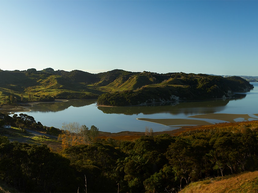 Kawhia Harbour, 2011. Photo by Norm Heke. Te Papa (76758) A panoramic photo of a still harbour and low-lying hills