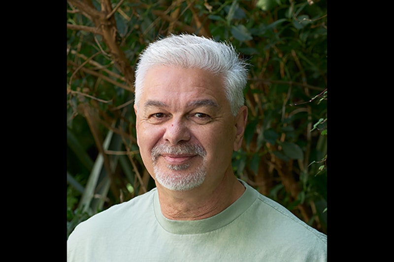 Head and shoulders of a man with white hair and a goatee beard