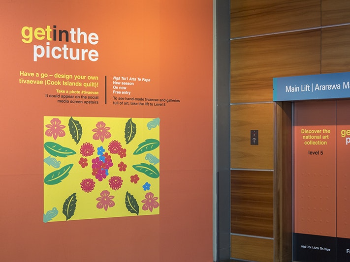 Ngā Toi, Get in the Picture, 2015. Photo by Kate Whitley. Te Papa (68836) An installation photo of a promotion of an exhibition called Get in the Picture. It's a poster next to an elevator door.