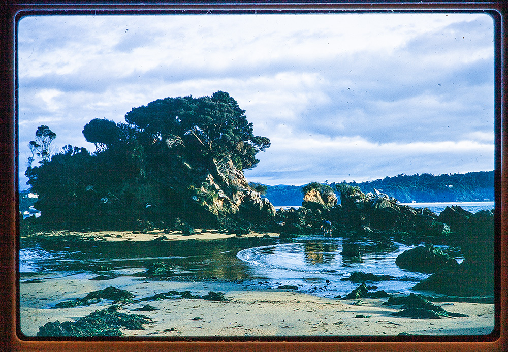 A slide image view of a rocky outcrop surrounded by an inlet.