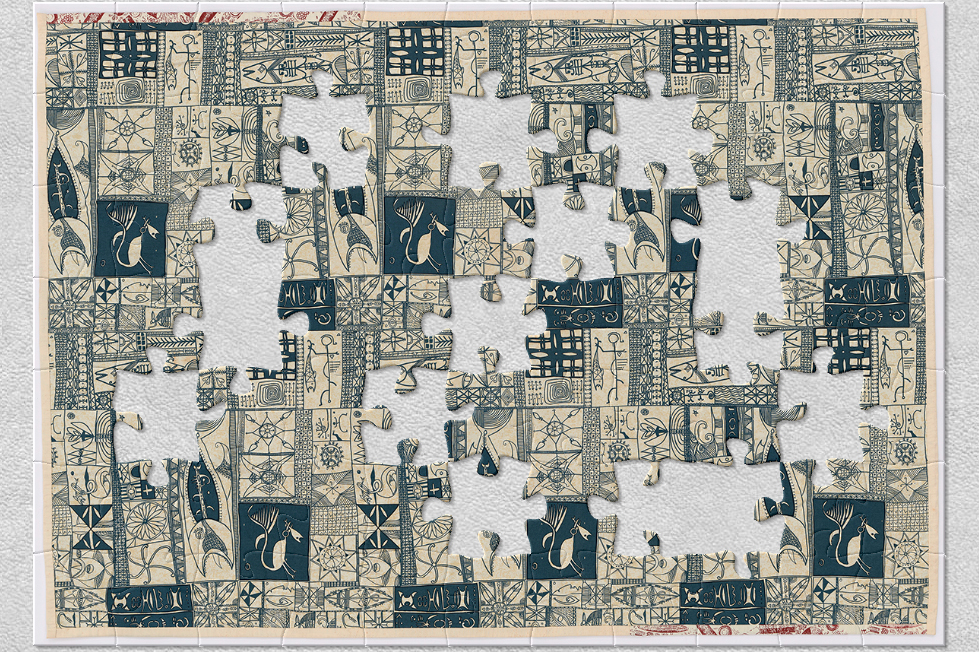 A cloth bed cover with blue and white patterns and designs stamped on it. There are jigsaw-shaped pieces missing from the image.