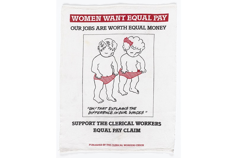 A teatowel showing two small children holding their pants open and looking down. The main message is "Oh! That explains the difference in our wages"
