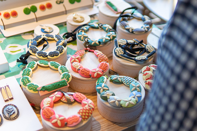 A display of coloured jewellery on a stall table