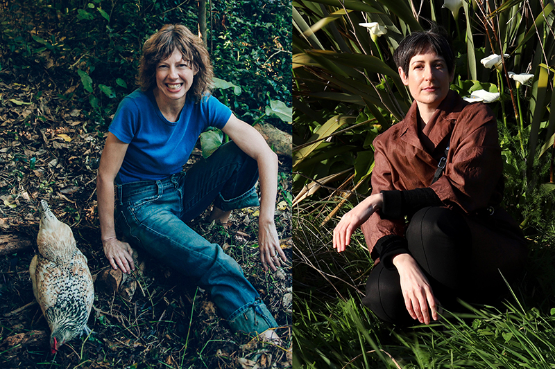 Two people sitting in green bushes. the person on the right has a speckled hen pecking at the ground next to them.