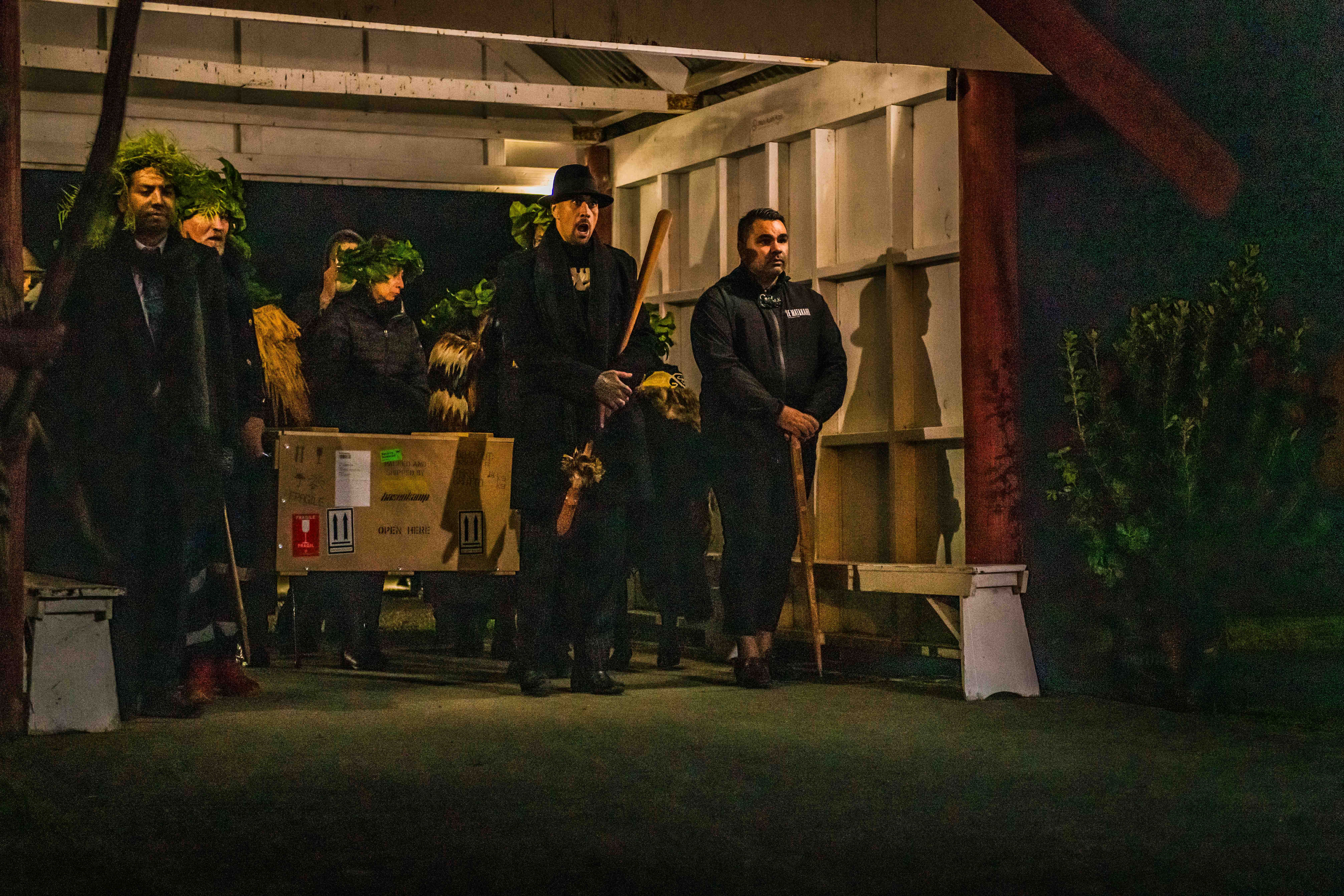 Members of Te Uri a Hau bringing their kōiwi into the marae setting