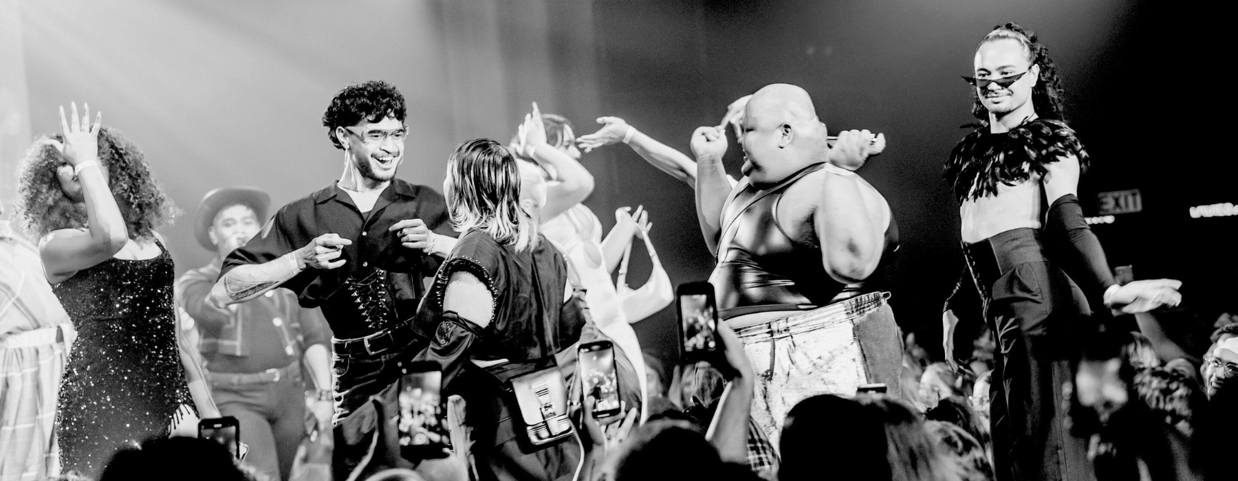 A black and white photo of people dancing on a stage.