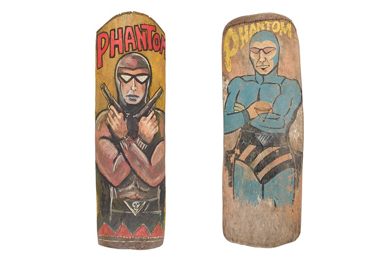 Two long wooden planks with cartoon image of The Phantom painted on it with the word Phantom on each.