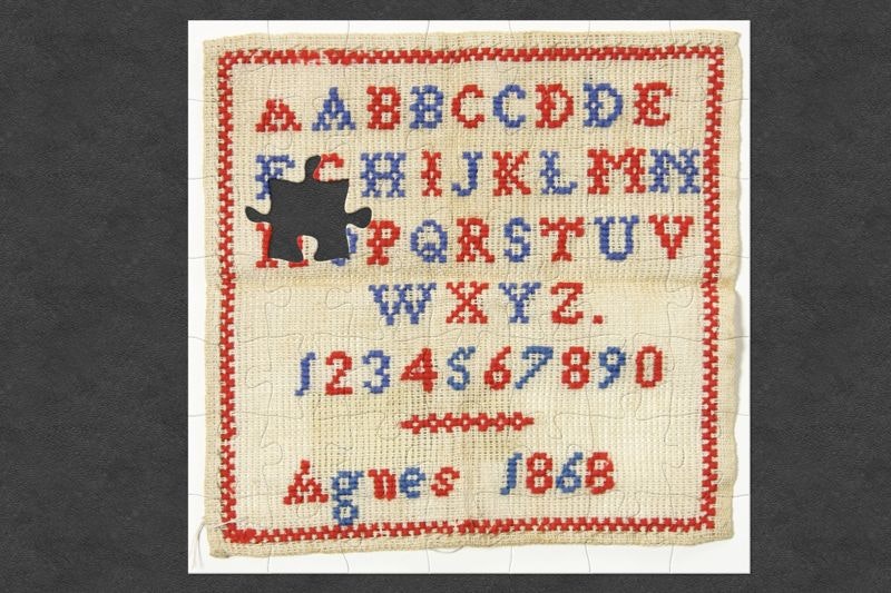 A needlepoint sampler with the alphabet, numbers and the words Agnes, 1868. It has jigsaw-shaped pieces missing