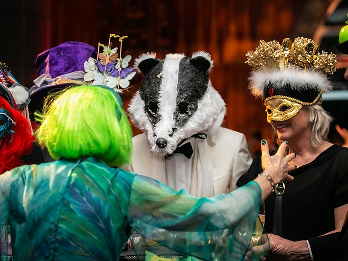 Surrealist Soiree, 2021. Photo by Jo Moore. Te Papa (175698) People dressed in costume and masks at a large party.