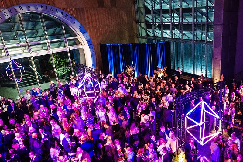 A lot of people at a party in a large venue