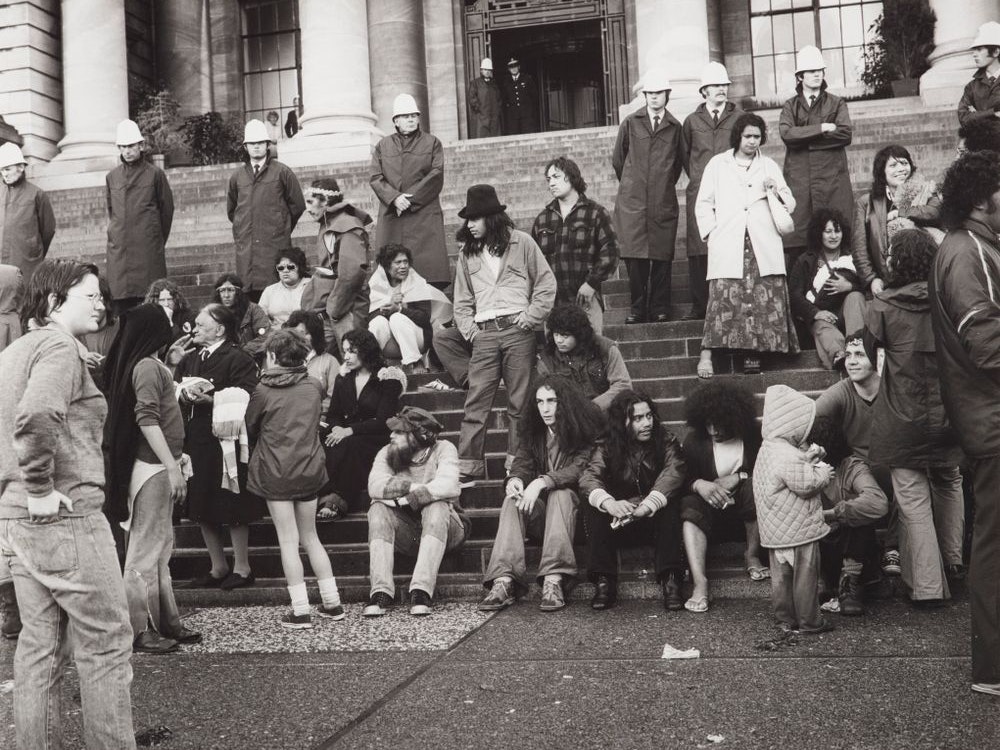 Maori Land March, 1975, Wellington, by Ans Westra. Purchased 1993 with New Zealand Lottery Grants Board funds. Te Papa (O.010219/02) Black and white photo of people standing and sitting on the steps of parliament.