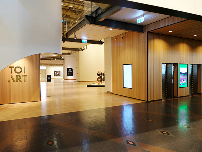 Level 4 gallery entrance, 2025. Photo by Rowan Moulder. Te Papa Gallery entrance, with artworks visible and lifts on right.