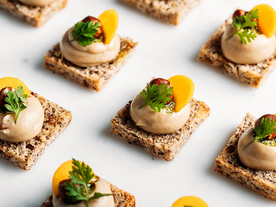 Canapés by Te Papa Venues chefs, 2024. Photo by Anna Briggs. Te Papa (263319) Small canapés with a mousse and piece of fruit and a green herb on each one.