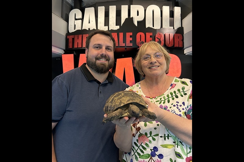 Malcolm Little and Christine Little with Torty. Photo by Tia Nepia-Su'a. Te Papa A man and a woman stand in front of Gallipoli the scale of our war gallery at Te Papa. The woman is holding a live tortoise.