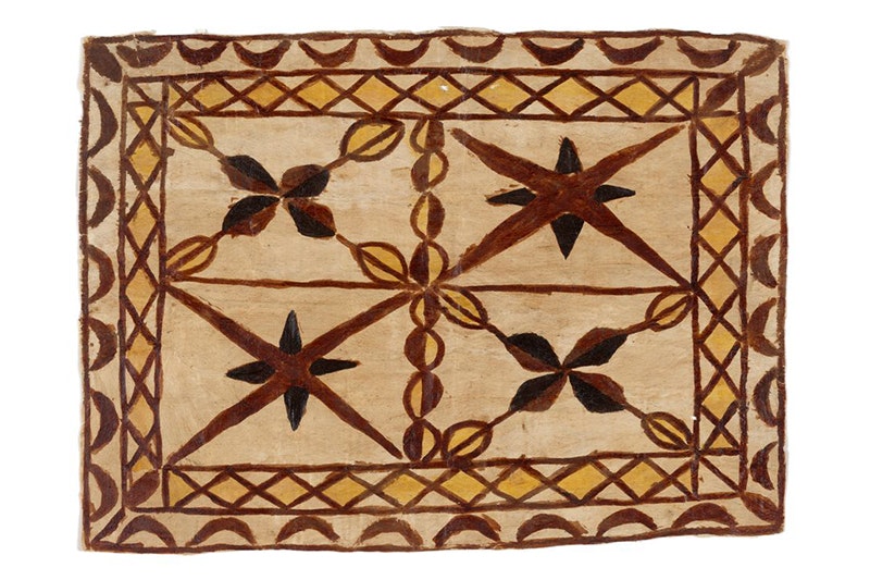 A piece of barkcloth with designs painted on it.