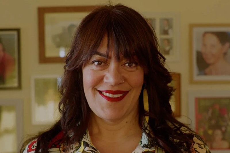 A head and shoulders photo of a woman smiling at the camera.