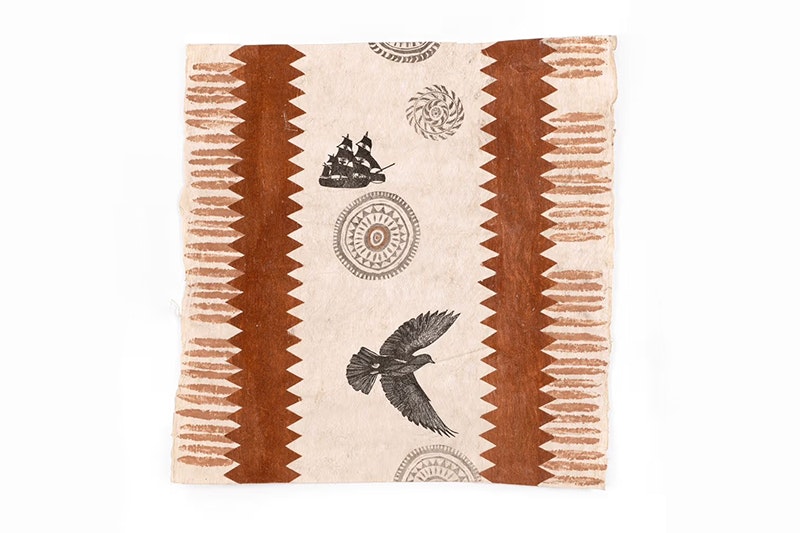 A light brown tapa cloth with dark brown painted on in zigzags and stripes. Also painted on are a bird and a sailing ship.