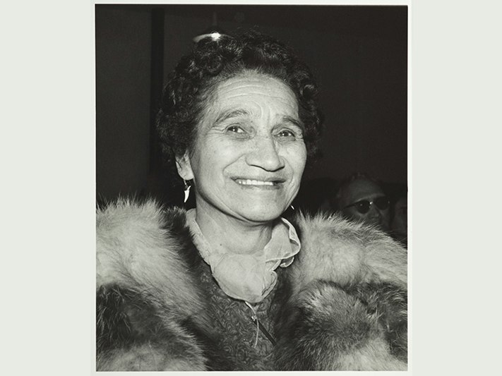 Dame Whina Cooper Production Ans Westra; photographer; 1960s; New Zealand. Purchased 1993 with New Zealand Lottery Grants Board funds. Te Papa (O.009946/04) A head and shoulders photograph of a woman wearing a fox stole and smiling.