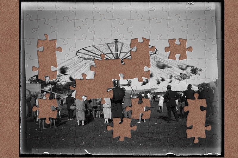 A black and white photo of a fairground ride with jigsaw shapes missing.