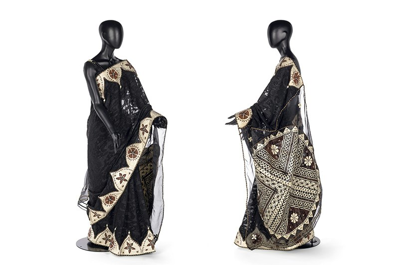 Frot and side views of a black mannequin wearing a sari made with silk, shells, and tapa cloth.